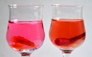 Pernambuco was used as a bright red dye as illustrated by the glasses of water containing a shaving of pernambuco wood. The glass on the right is slightly caustic.
